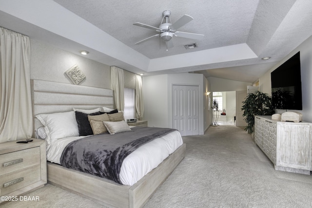 7 Foxfords Chase, Ormond Beach, FL 32174 - bedroom with light colored carpet, a textured ceiling, a raised ceiling, a closet, and ceiling fan