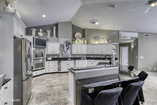 7 Foxfords Chase, Ormond Beach, FL 32174 - kitchen with stainless steel appliances, ceiling fan, lofted ceiling, a breakfast bar, and open shelves
