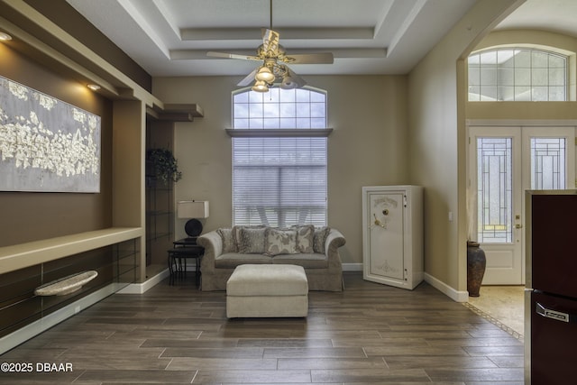 7 Foxfords Chase, Ormond Beach, FL 32174 - living area with a ceiling fan, a tray ceiling, and dark wood finished floors