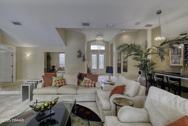 7 Foxfords Chase, Ormond Beach, FL 32174 - living room with arched walkways, a chandelier, and lofted ceiling
