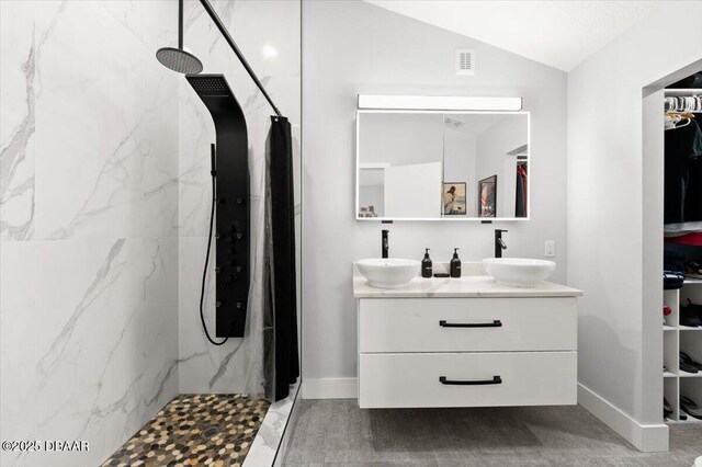 5967 Riverside Dr, Port Orange, FL 32127 - full bathroom with a marble finish shower, double vanity, lofted ceiling, and a spacious closet