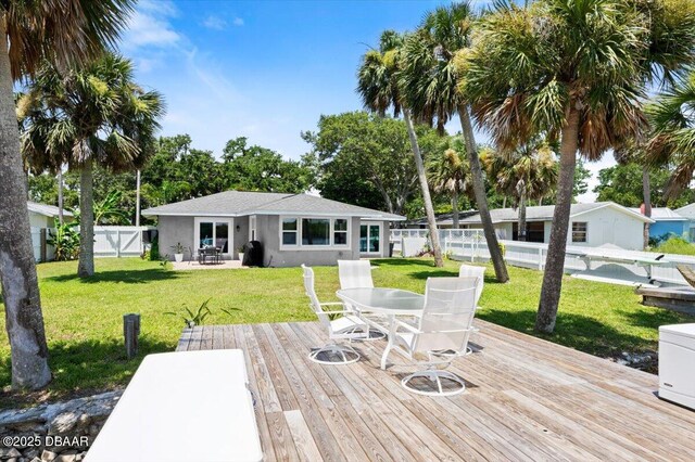 5967 Riverside Dr, Port Orange, FL 32127 - deck with outdoor dining area and a fenced backyard