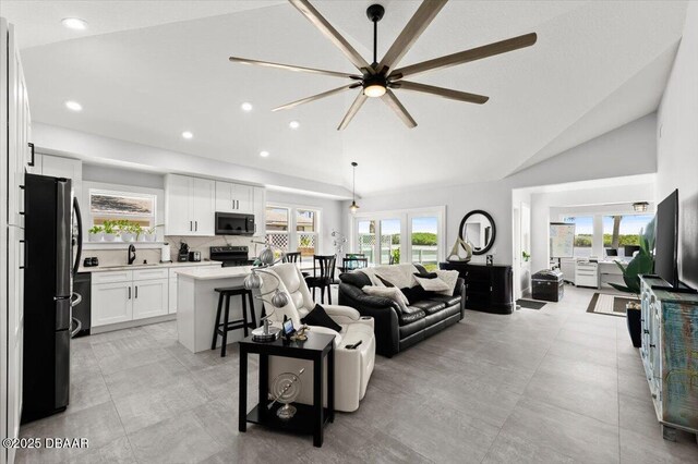 5967 Riverside Dr, Port Orange, FL 32127 - living room with a ceiling fan, vaulted ceiling, and recessed lighting