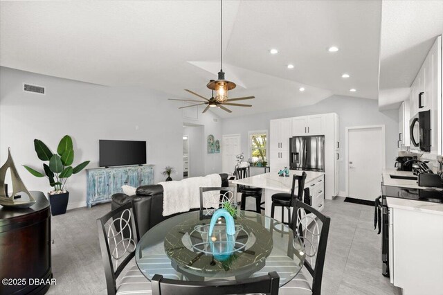 5967 Riverside Dr, Port Orange, FL 32127 - dining room with lofted ceiling, a ceiling fan, and recessed lighting