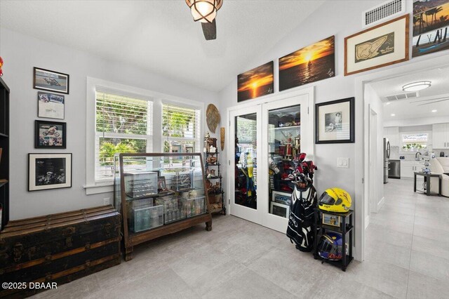 5967 Riverside Dr, Port Orange, FL 32127 - corridor with vaulted ceiling, plenty of natural light, and tile patterned floors