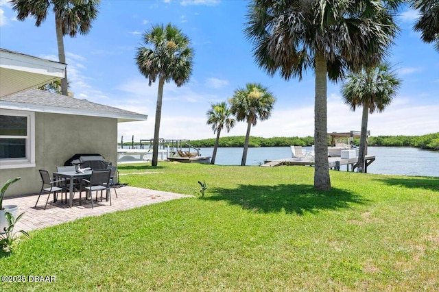 5967 Riverside Dr, Port Orange, FL 32127 - view of green lawn with a water view and a patio area