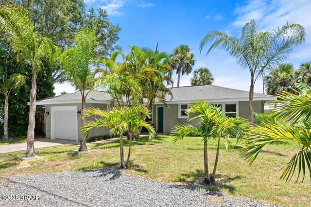5967 Riverside Dr, Port Orange, FL 32127 - view of front of house featuring a garage, concrete driveway, a front lawn, and stucco siding