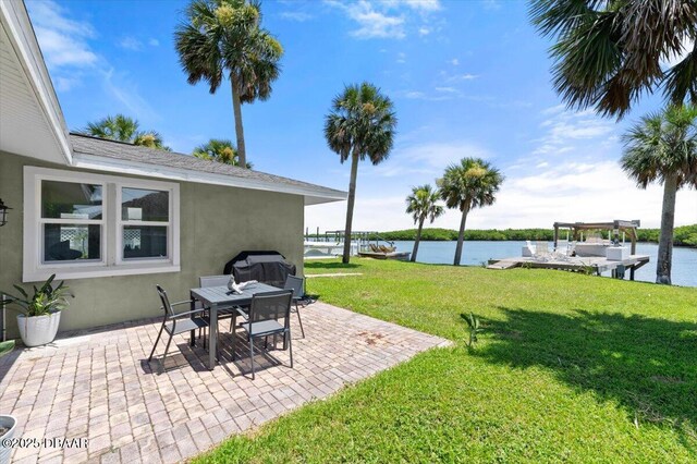 5967 Riverside Dr, Port Orange, FL 32127 - view of green lawn with a water view and a patio area