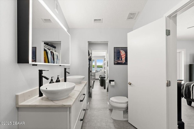 5967 Riverside Dr, Port Orange, FL 32127 - full bath featuring double vanity, ensuite bath, and a textured ceiling