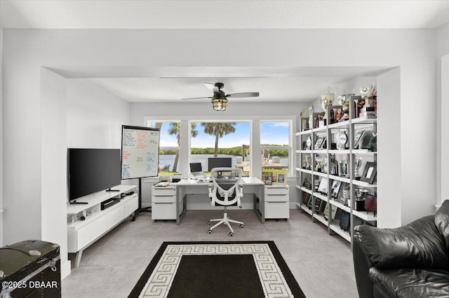 5967 Riverside Dr, Port Orange, FL 32127 - home office with a ceiling fan and concrete flooring