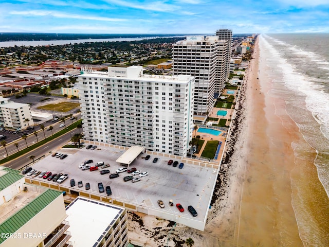 bird's eye view featuring a city view, a water view, and a beach view