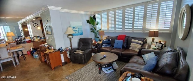 living room with ornamental molding and tile patterned flooring