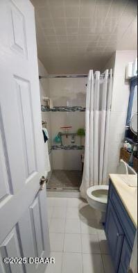 full bath featuring a stall shower, vanity, toilet, and tile patterned floors