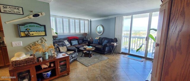 living room featuring light tile patterned floors, expansive windows, plenty of natural light, and crown molding