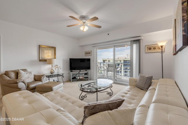 carpeted living area featuring ceiling fan