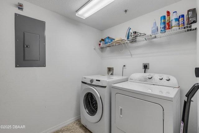 clothes washing area featuring laundry area, electric panel, baseboards, and independent washer and dryer