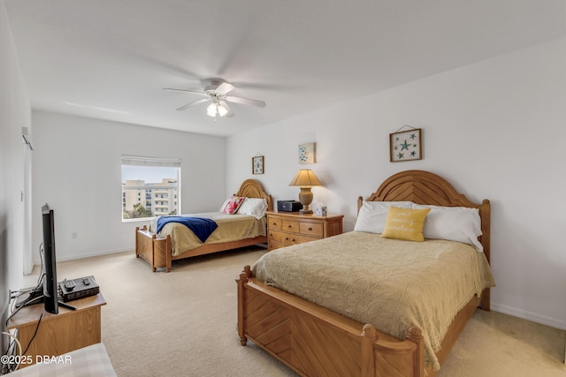 bedroom featuring light carpet, baseboards, and a ceiling fan