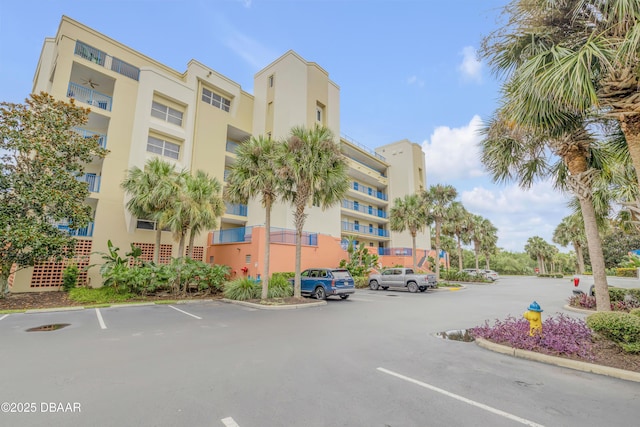 view of building exterior featuring uncovered parking