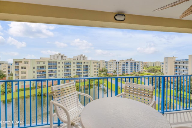 balcony featuring outdoor dining area and a city view