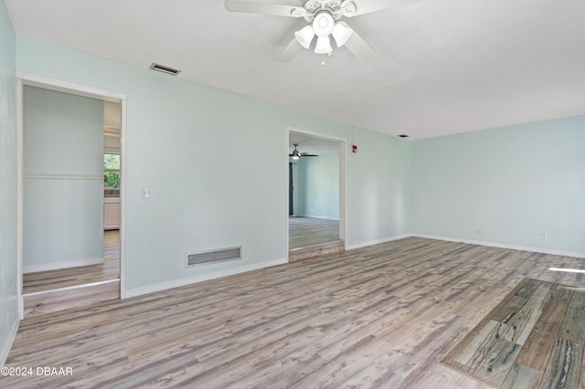 empty room with light hardwood / wood-style floors and ceiling fan