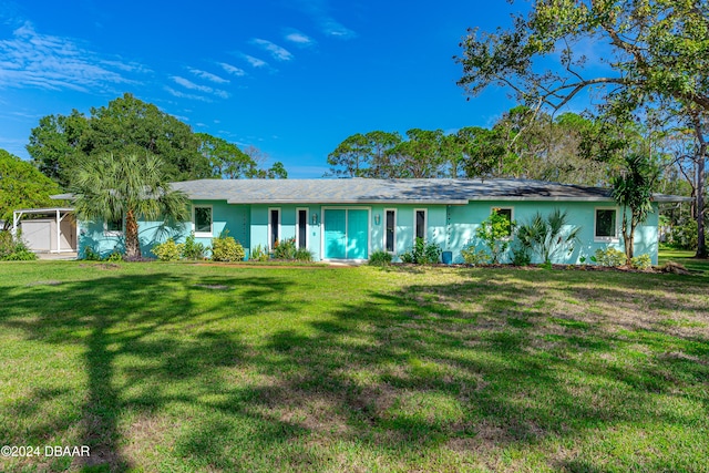 single story home featuring a garage and a front yard