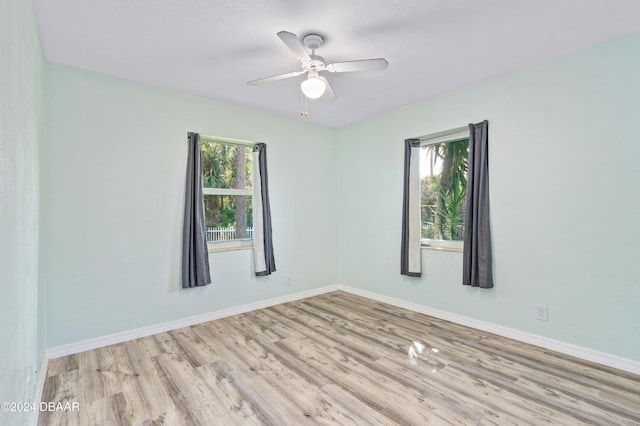 spare room with ceiling fan and light hardwood / wood-style flooring