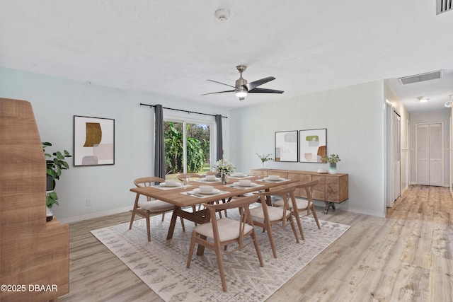 dining room with ceiling fan and light hardwood / wood-style flooring