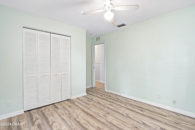 unfurnished bedroom featuring light hardwood / wood-style flooring, a closet, and ceiling fan