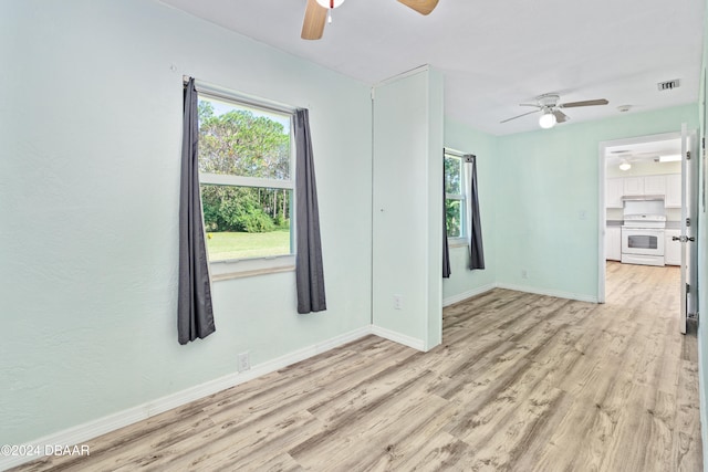 spare room featuring light hardwood / wood-style flooring and ceiling fan