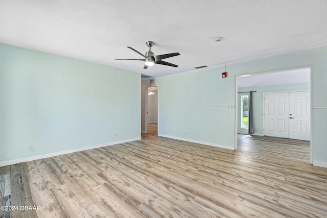 empty room with light hardwood / wood-style flooring and ceiling fan