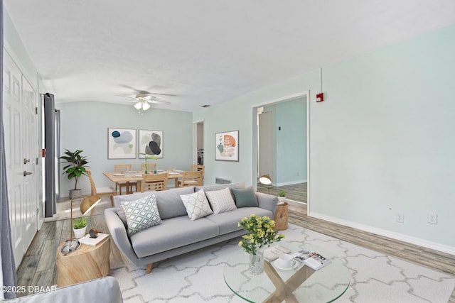 living room with hardwood / wood-style floors and ceiling fan