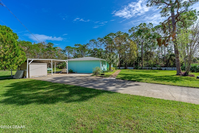 view of front of home with a storage shed, a front lawn, and a carport