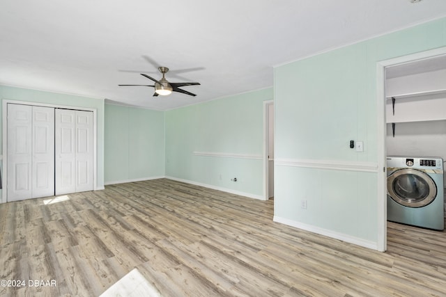 unfurnished bedroom with light hardwood / wood-style flooring, ceiling fan, and washer / dryer