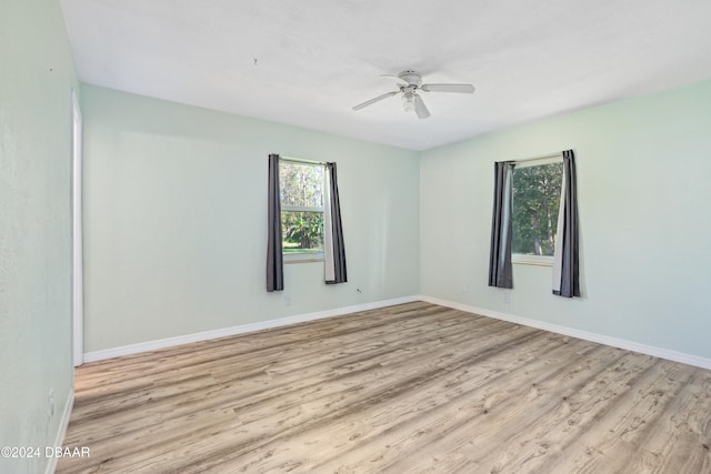 empty room with light hardwood / wood-style floors and ceiling fan