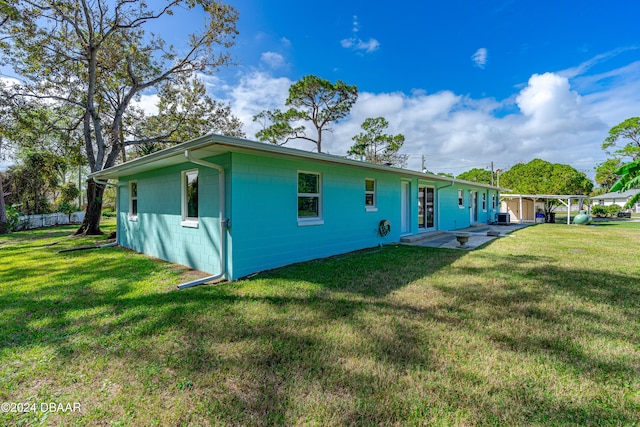 rear view of property featuring a lawn