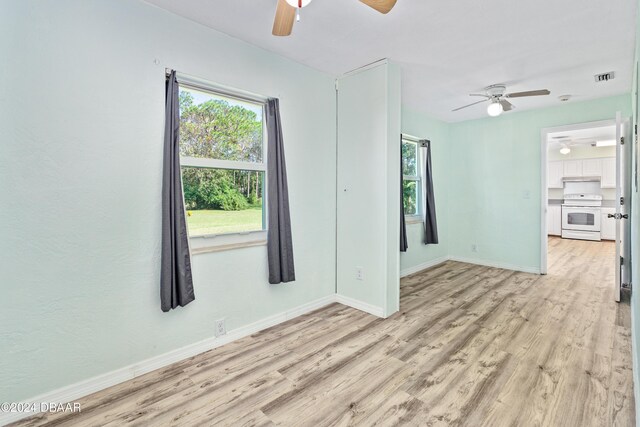 spare room featuring ceiling fan and light hardwood / wood-style flooring