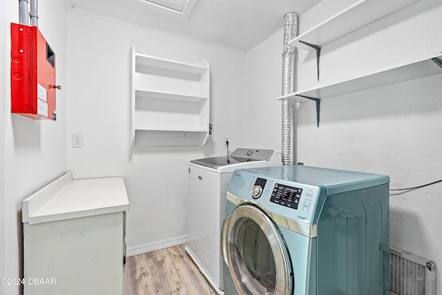 laundry room featuring light wood-type flooring and washer and clothes dryer