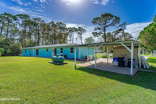 back of house with a yard and a carport