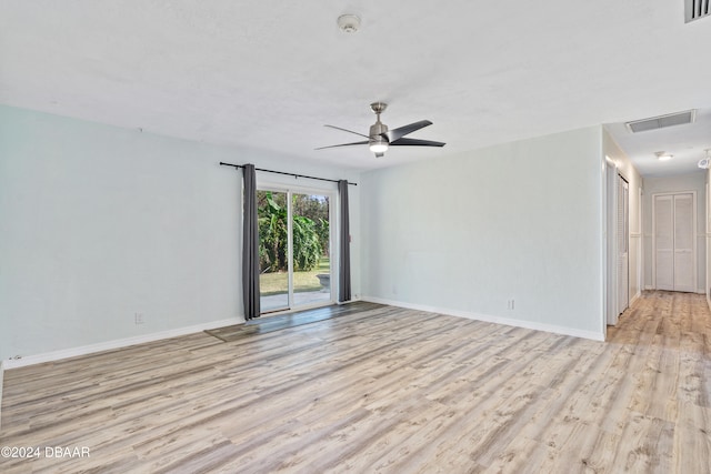 empty room with ceiling fan and light hardwood / wood-style floors