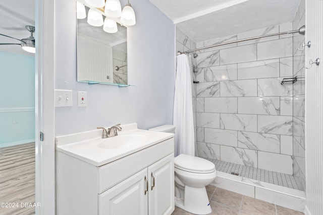 bathroom featuring toilet, vanity, a shower with shower curtain, and tile patterned flooring