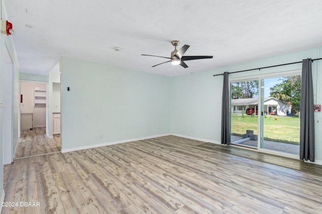 empty room featuring ceiling fan and light wood-type flooring