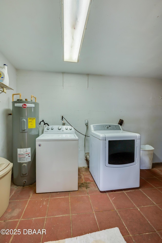 washroom with independent washer and dryer, tile patterned floors, and water heater