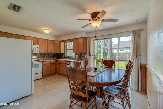 interior space featuring ceiling fan, sink, and a textured ceiling