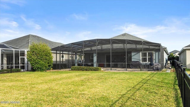 back of property with a lanai and a yard