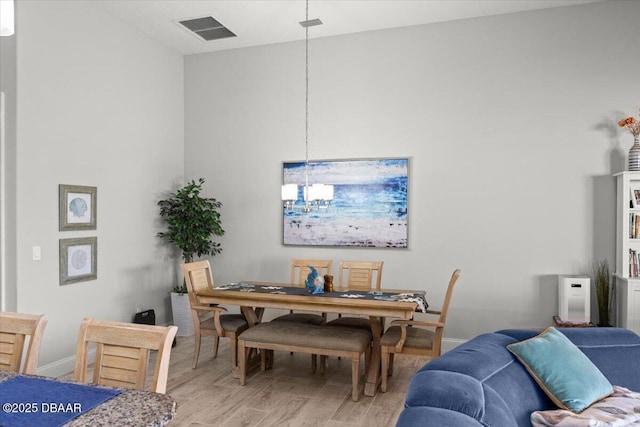 dining room with a chandelier and light hardwood / wood-style flooring