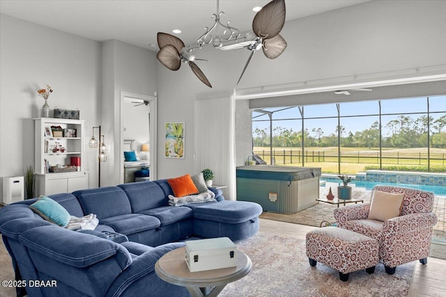 living room with ceiling fan and light hardwood / wood-style floors