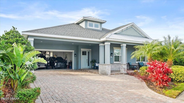 view of front of house with covered porch and a garage