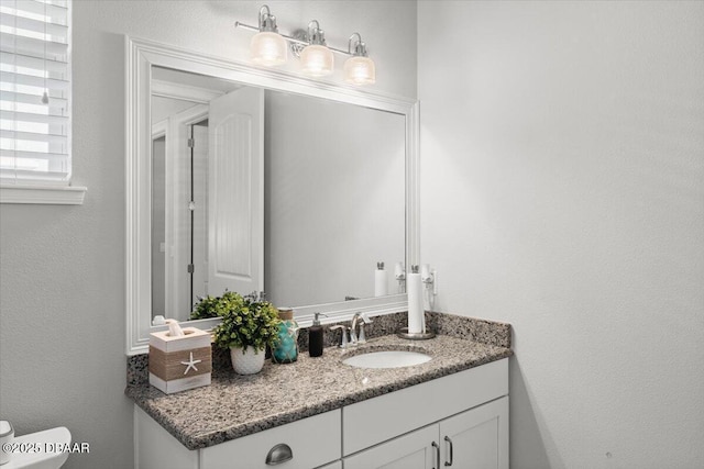 bathroom featuring toilet and vanity