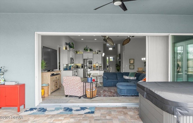 living room featuring sink and ceiling fan