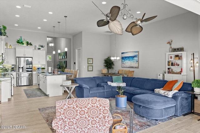 living room with ceiling fan and light hardwood / wood-style floors